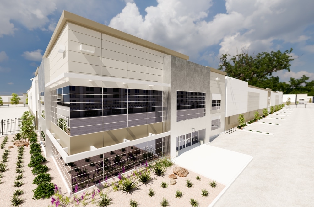 An architectural rendering of a modern commercial building featuring a two-story glass facade, light-colored paneling, and desert landscaping.